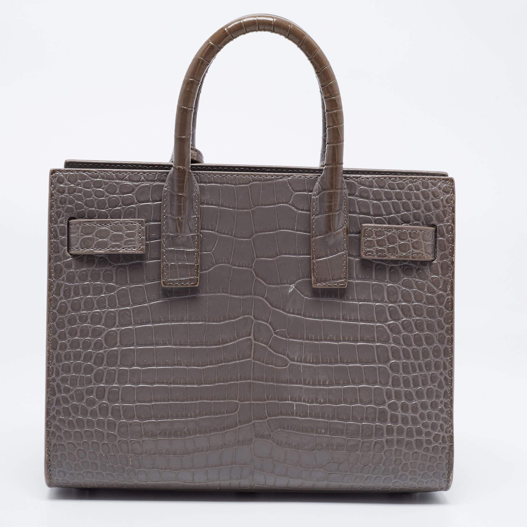 Bringing a mix of timeless fashion and fine craftsmanship is this tote. The bag comes with a durable exterior, comfortable handles, shiny hardware, and a capacious interior. Fine elements complete the tote in a luxe way.

Includes: Detachable Strap,