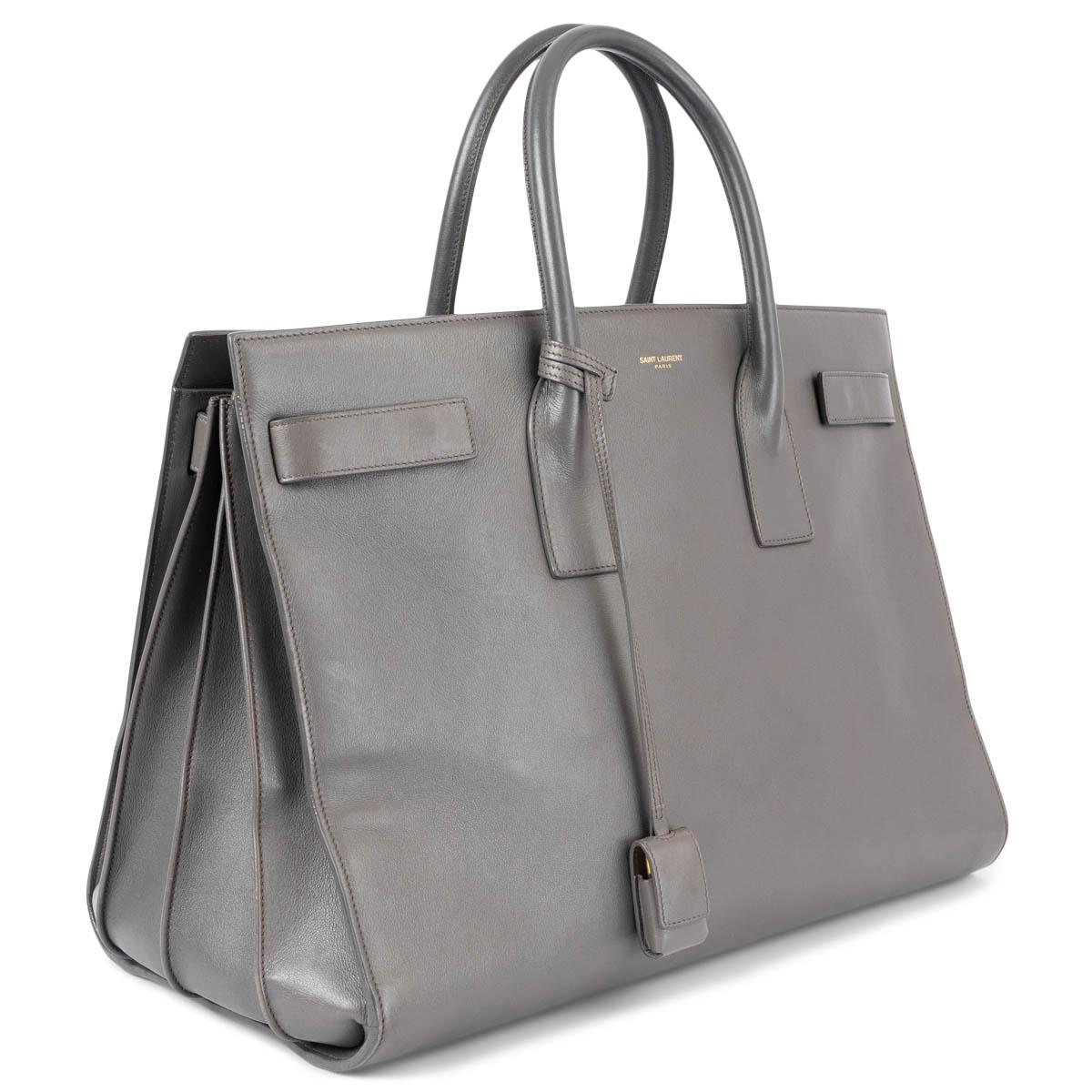 100% authentic Saint Laurent Large Sac de Jour in grey smooth leather with gold-tone hardware. The design features accordion sides, a detachable padlock in leather case and four snap tabs on the side. The interior is lined in grey suede and divided