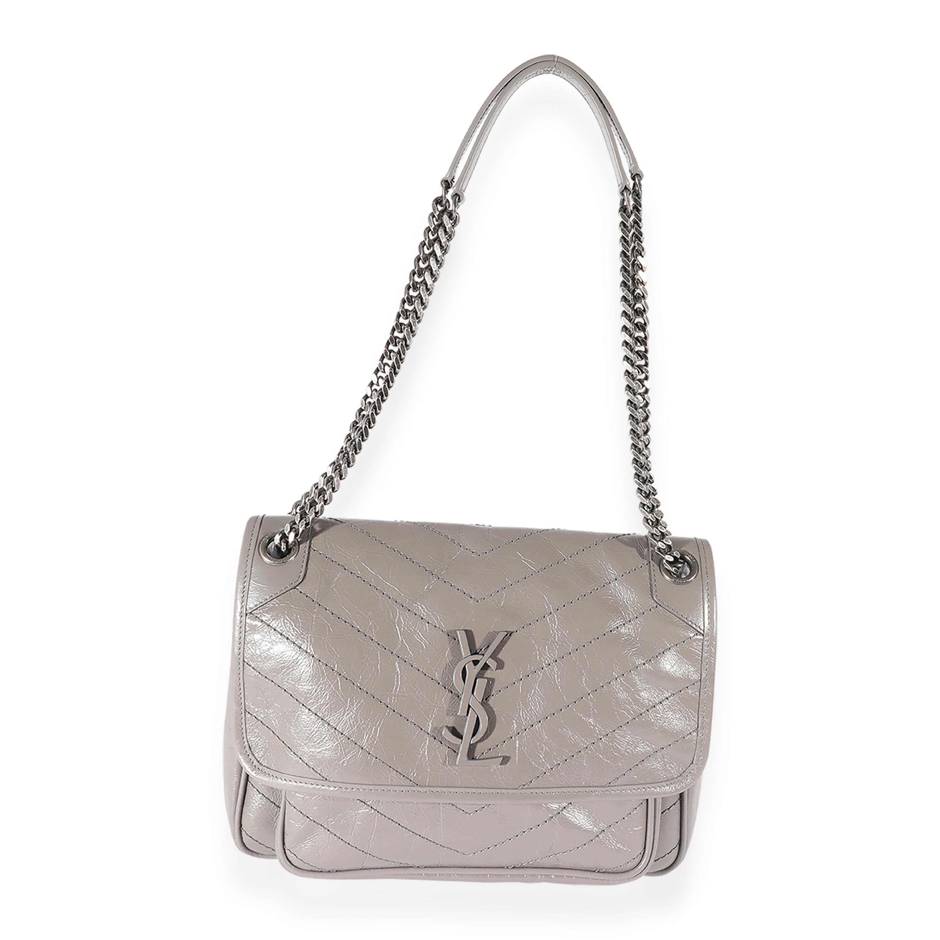Listing Title: Saint Laurent Grey Leather Medium Niki
SKU: 125508
MSRP: 2690.00
Condition: Pre-owned 
Handbag Condition: Very Good
Condition Comments: Very Good Condition. Plastic at some hardware. Light fraying at exterior base. Light scuffing at