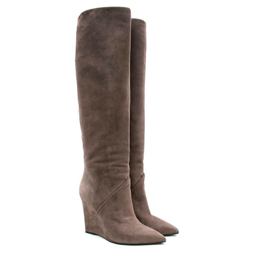 Saint Laurent long boots crafted from grey suede featuring a pointed-toe and a wedge heel. 

- Leather insole
- Knee boots
- Made in Italy

Please note, these items are pre-owned and may show signs of being stored even when unworn and unused. This