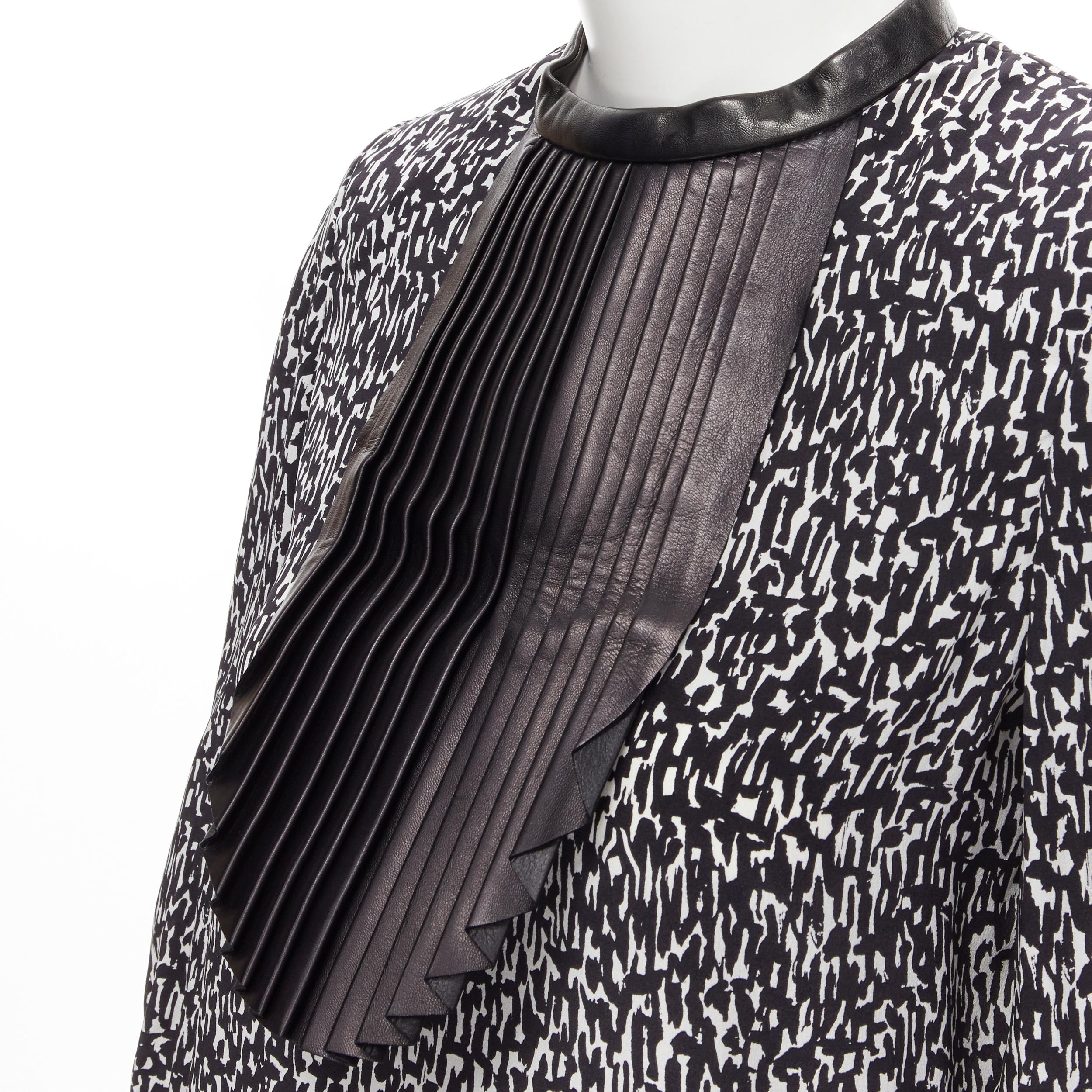 SAINT LAURENT Hedi Slimane 2012 black pleated leather bib white print silk blouse FR38 S 
Reference: MELK/A00140 
Brand: Saint Laurent 
Designer: Hedi Slimane 
Collection: 2012 
Material: Silk 
Color: Black 
Pattern: Abstract 
Closure: Button 
Extra