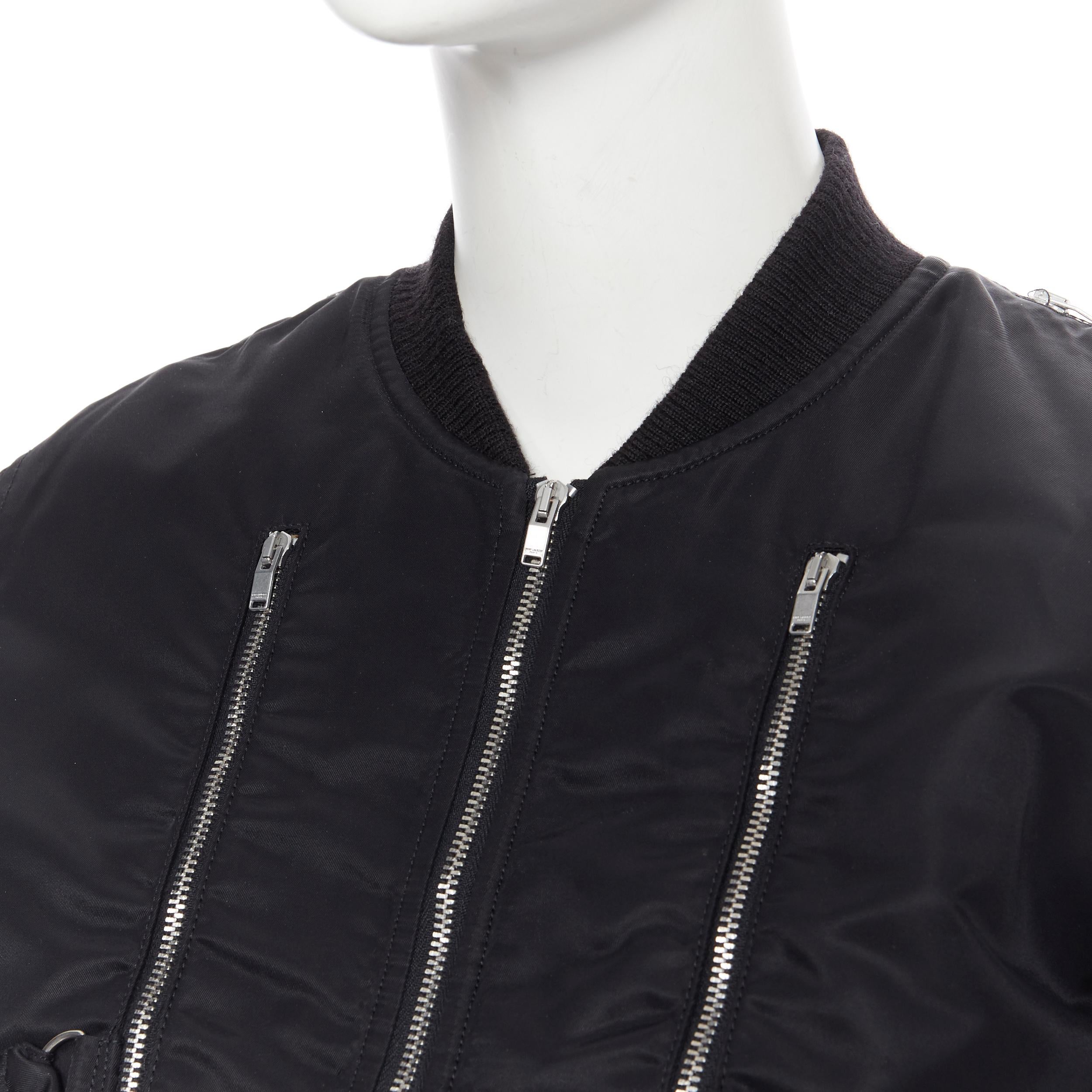 SAINT LAURENT HEDI SLIMANE 2015 black nylon zipper bondage strap MA-1 bomber F34
Brand: Saint Laurent
Designer: Hedi Slimane
Collection: 2015
Model Name / Style: Bomber jacket
Material: Nylon
Color: Black
Pattern: Solid
Closure: Zip
Extra Detail: