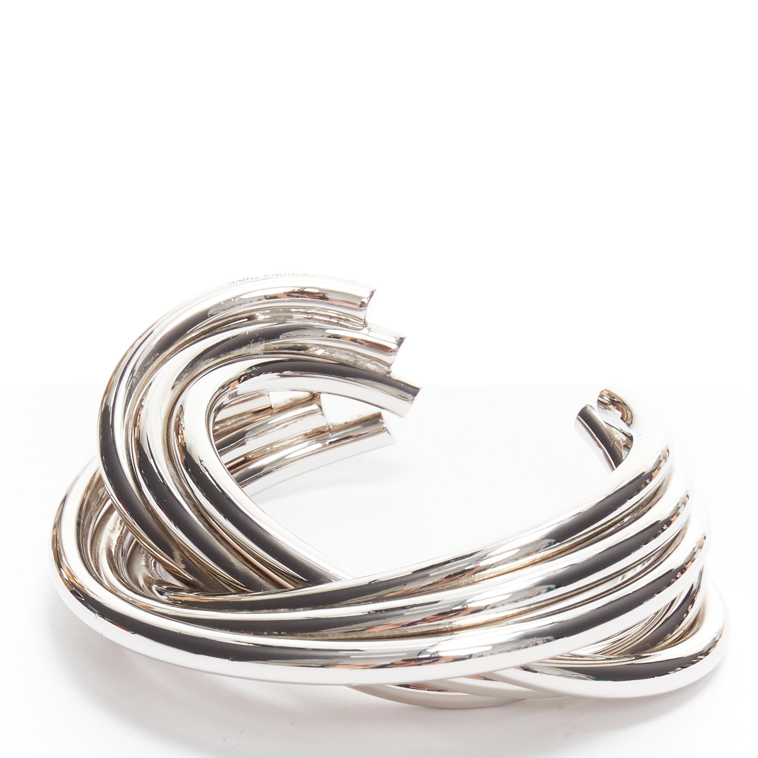 SAINT LAURENT Hedi Slimane silver brass architectural 6 layer twist cuff 
Reference: TGAS/B01757 
Brand: Saint Laurent 
Designer: Hedi Slimane 
Color: Silver 
Pattern: Solid 
Extra Detail: Hedi Slimane for Saint Laurent. Designed to look like 6