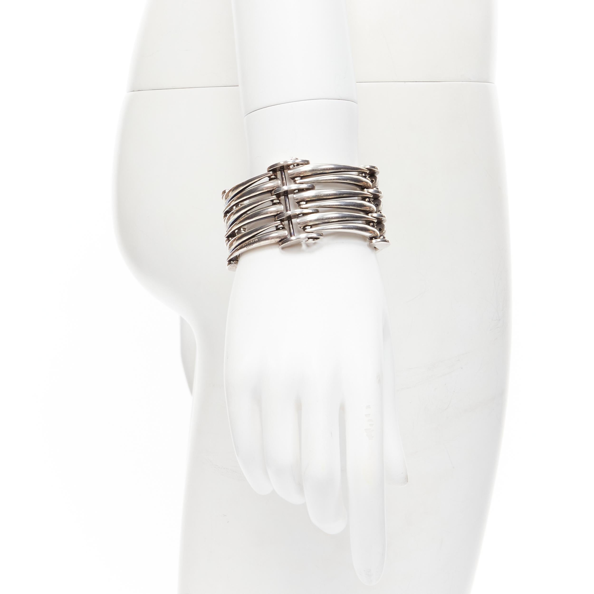 SAINT LAURENT Hedi Slimane silver metal claw clasp wide bracelet cuff 
Reference: TGAS/B01778 
Brand: Saint Laurent 
Designer: Hedi Slimane 
Material: Metal 
Color: Silver 
Pattern: Solid 
Closure: Clasp 
Extra Detail: Design by Hedi Slimane.