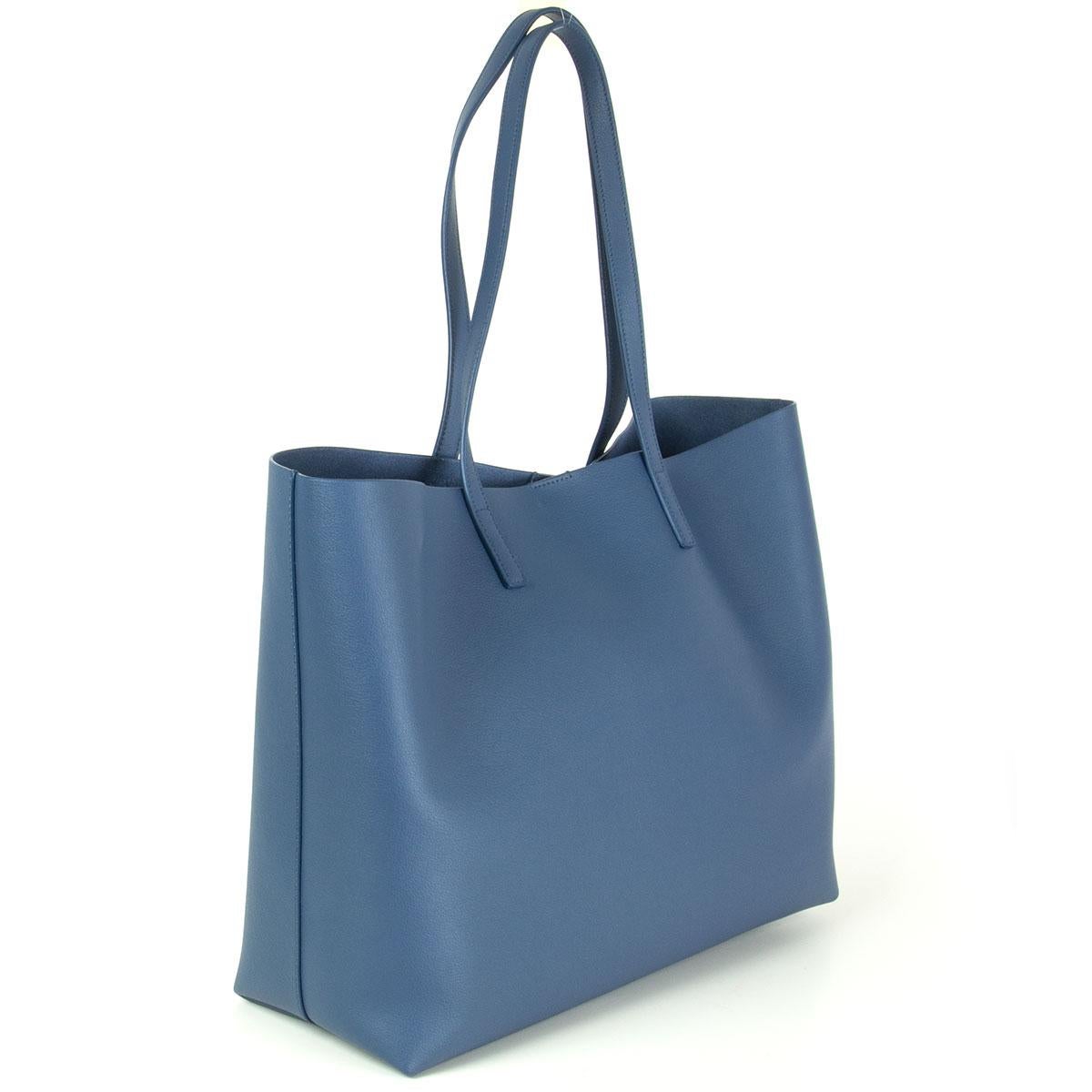 Saint Laurent large shopper tote in indigo blue calfskin. Magnetic button closure on top, unlined featuring internal zipped pouch. Has been worn once and is in virtually new condition. Comes with dust bag. 

Height 28cm (10.9in)
Width 35cm