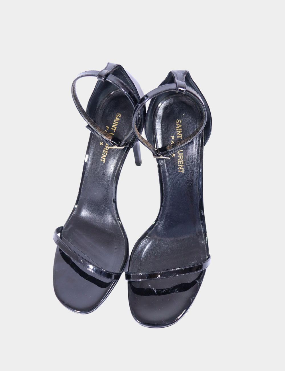 Sleek, sultry, and unmistakably chic, these Saint Laurent Jane Patent Leather Sandals are the epitome of timeless glamour. Featuring a minimalist single-strap front and a high stiletto heel, this black patent leather design delivers maximum impact