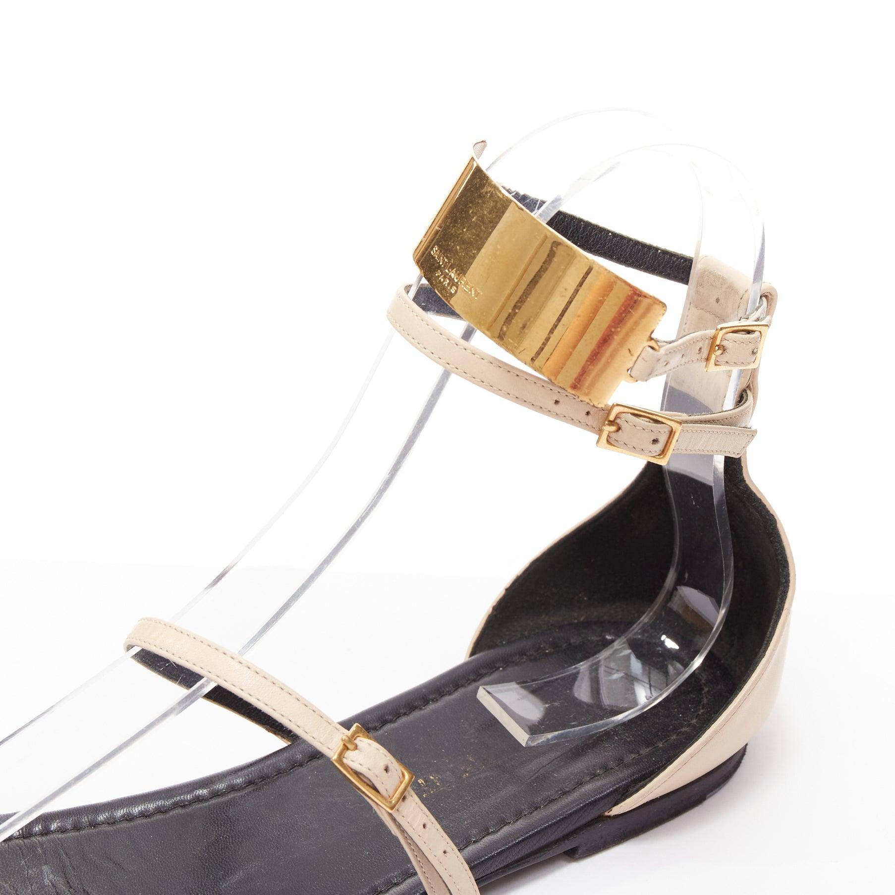 SAINT LAURENT Janis nude leather gold metal bar flat sandals EU38.5
Reference: CNPG/A00080
Brand: Saint Laurent
Designer: Anthony Vaccarello
Model: Janis
Material: Leather, Metal
Color: Nude, Gold
Pattern: Solid
Closure: Ankle Strap
Lining: Black