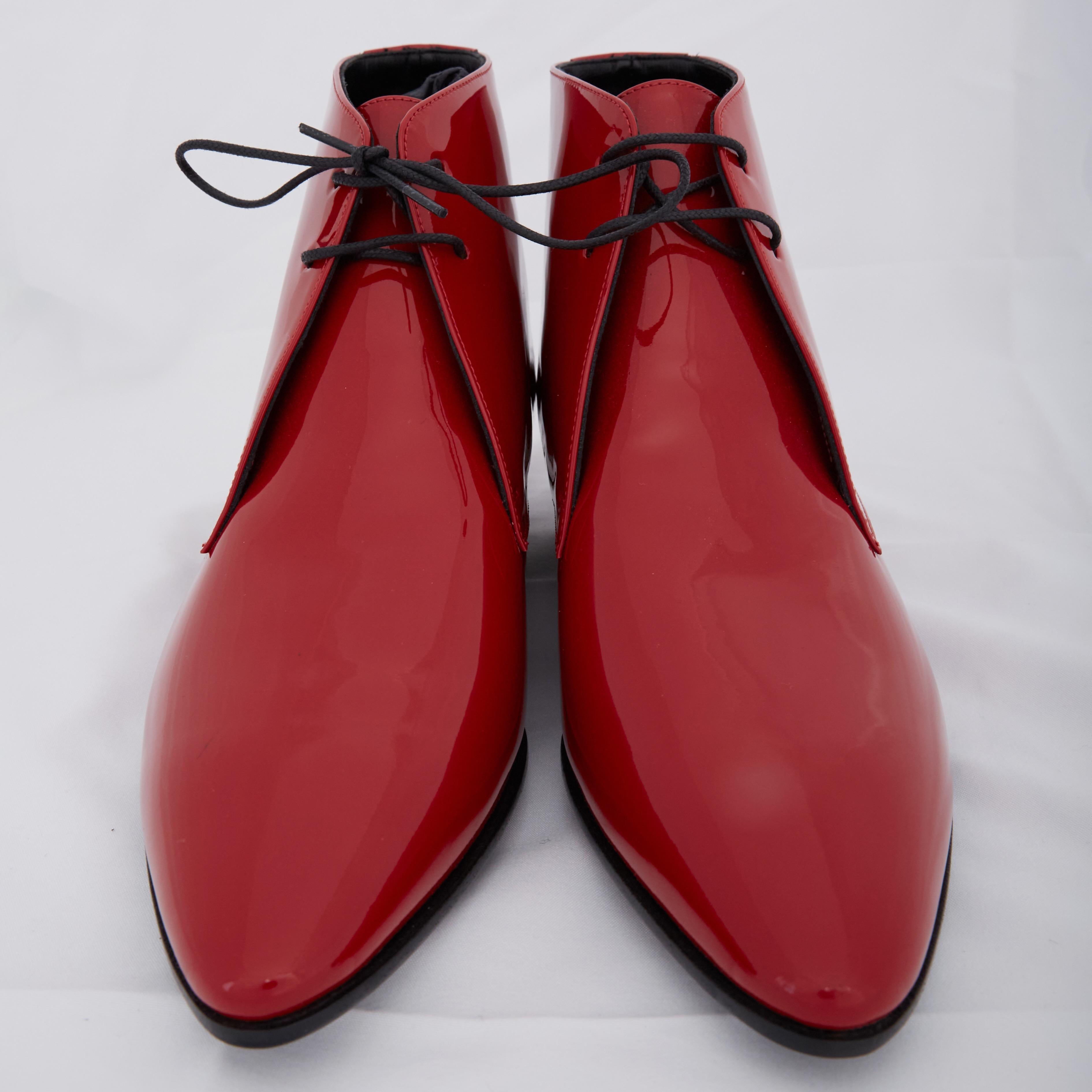 Women’s red ‘Jonas’ lace-up heeled ankle boots from Saint Laurent. Made of smooth patent leather. They feature a leather sole with a rubber insert.

COLOR: Red
MATERIAL: Patent leather
ITEM CODE: 581845
SIZE:  EU 39 / 8 US
HEEL HEIGHT: 25 mm /
