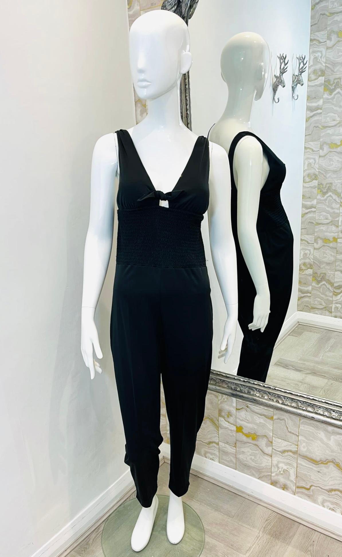 Saint Laurent Jumpsuit

Black, sleeveless jumpsuit designed with V-Neck centre tie detailing.

Featuring wide, elasticated insert to the waist and carrot pants.

Size – 36FR

Condition – Very Good

Composition – 80% Triacetate, 20% Polyester