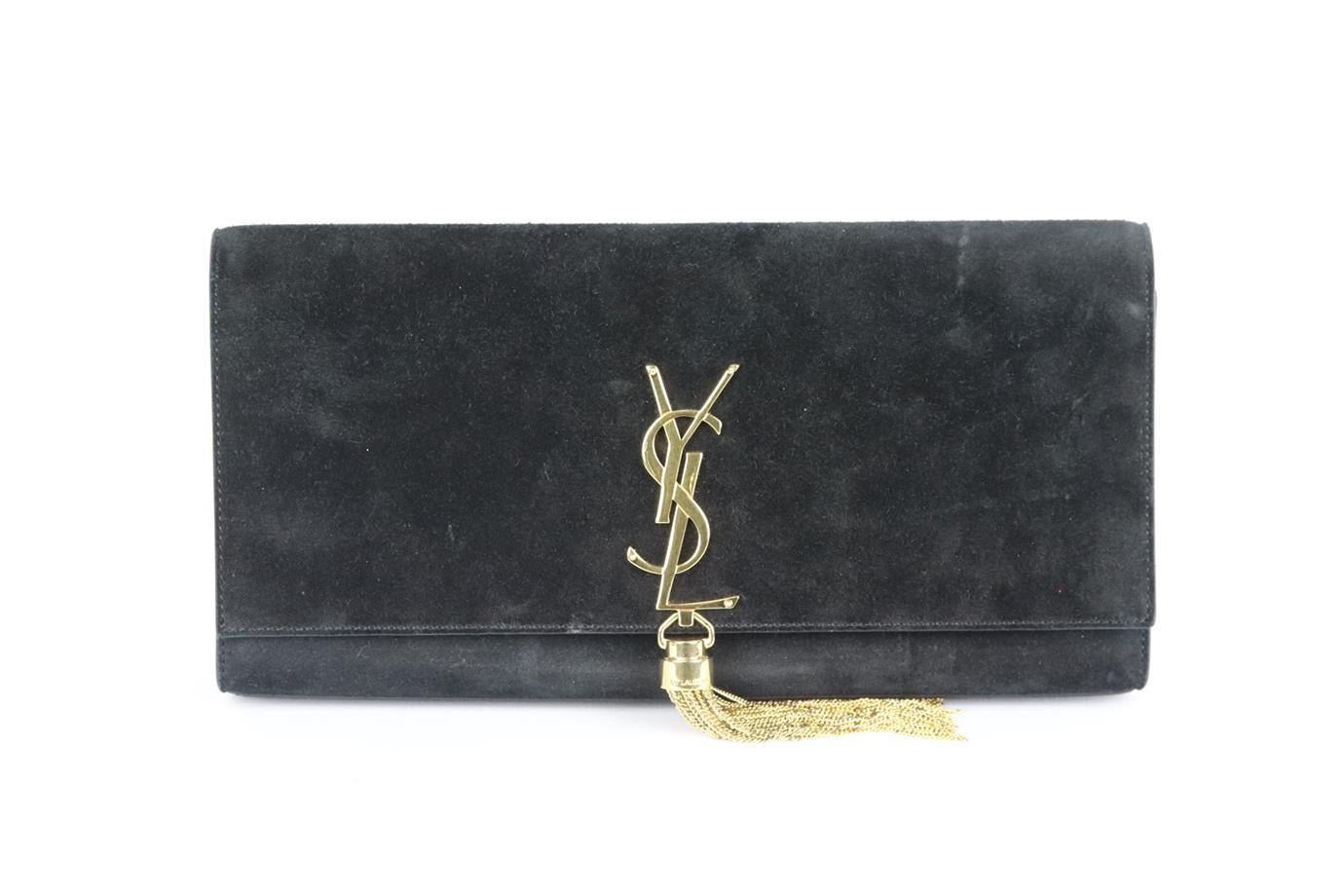 Saint Laurent Kate Monogramme suede clutch. Made from black suede with large gold-tone YSL plaque and tassel on the front, it has a large internal compartment with card slot. Black. Magnetic snap fastening at front. Does not come with box or