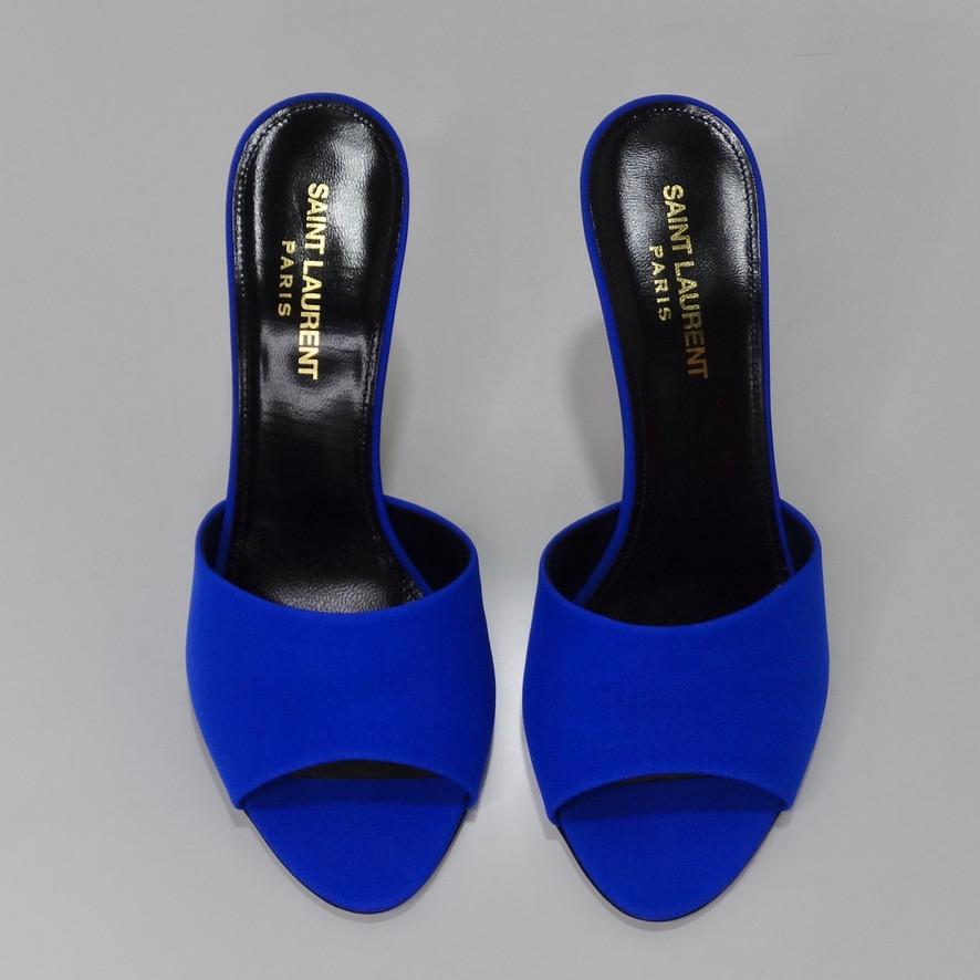 Incredible Saint Laurent mule style heels in the most stunning electric blue shade. Classic silk slip on heels featuring leather soles and a 3.75 in heel. These are the perfected elevated rendition of your go to versatile heel as this eye catching