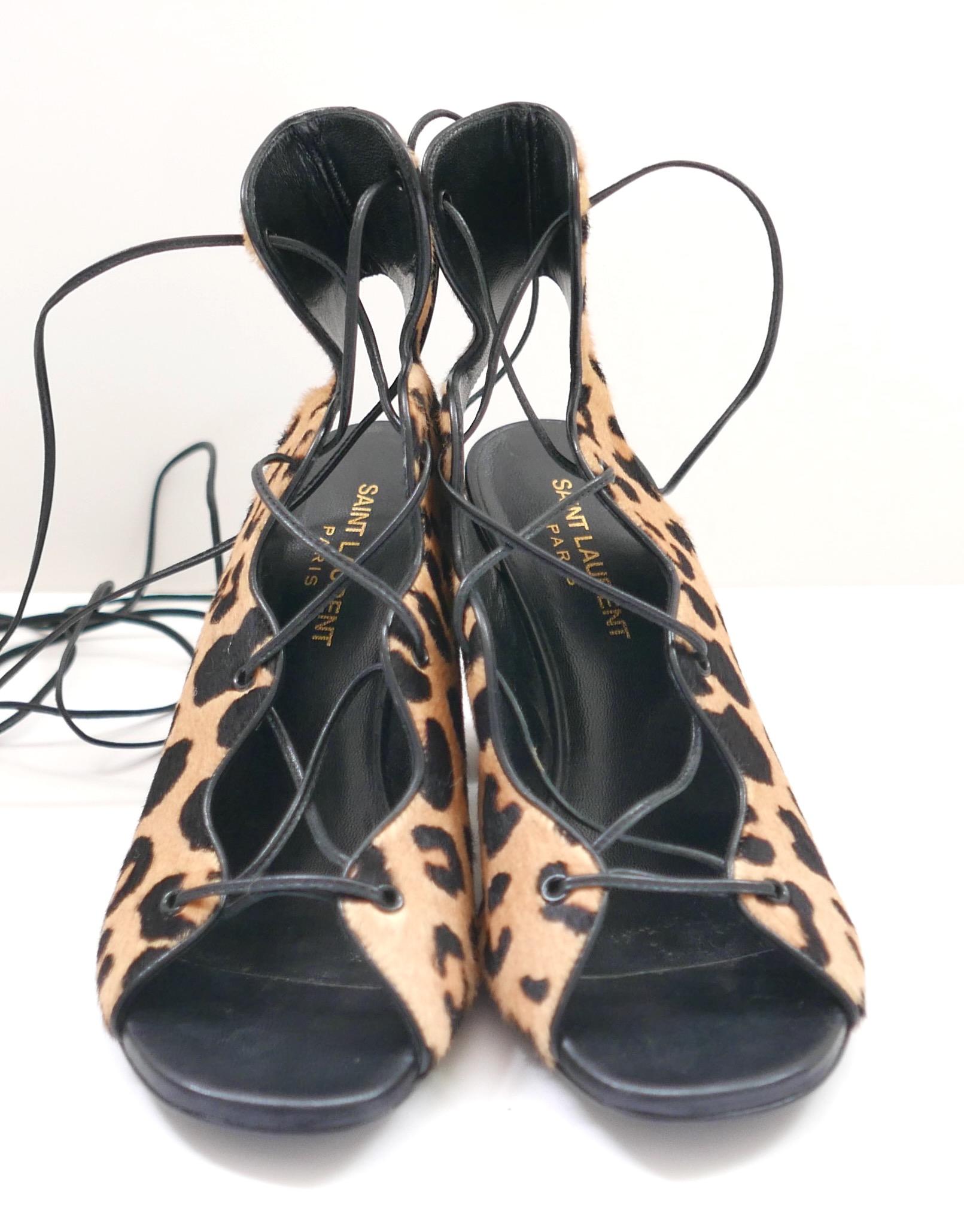 Fabulous Saint Laurent leopard print calf hair lace-up sandals. Bought for $895 and worn once. Come with dustbag. Made from soft animal print calf hair and black leather, they have cut-away fronts, long waxed laces that wrap up the ankles and chunky