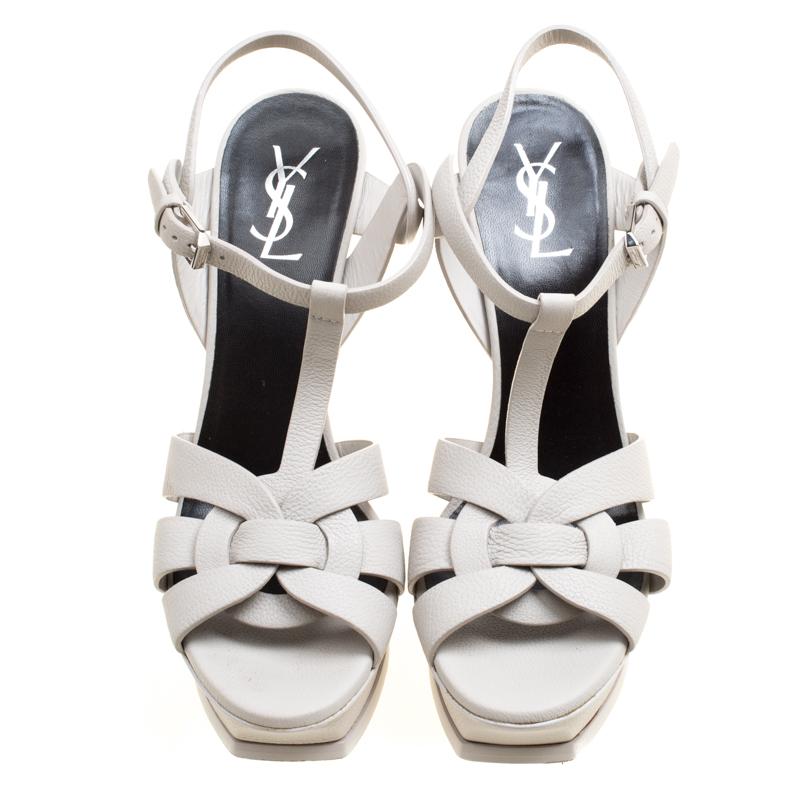 This amazing pair of grey sandals is from Saint Laurent Paris. They have been crafted from leather and styled with intertwining straps at the toe. The Tribute sandals come with adjustable ankle fastenings, comfortable insoles, and 14.5 cm