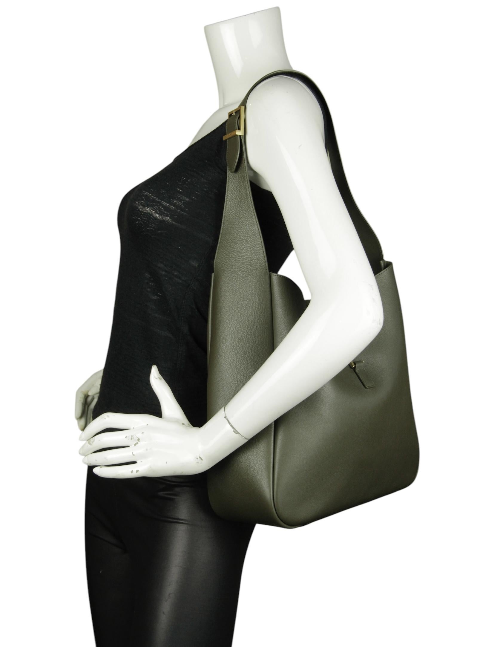 Saint Laurent Light Musk Green Large Le 5 à 7 Supple Leather Shoulder bag

Made In: Italy
Color: Light musk green
Hardware: Gold
Materials: Calfskin leather, metal
Lining: Black suede 
Closure/Opening: Open with center leather piece
Exterior