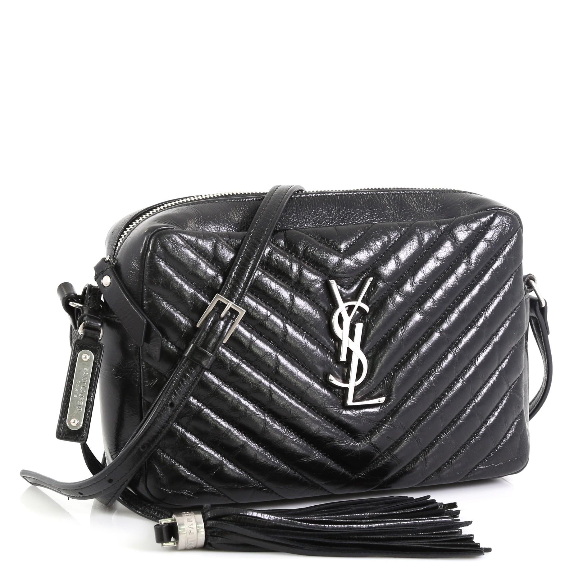 This Saint Laurent Lou Camera Bag Matelasse Chevron Leather Small, crafted from black matelasse chevron leather, features long leather strap, YSL monogram logo at the front, and silver-tone hardware. Its zip closure opens to a black fabric interior