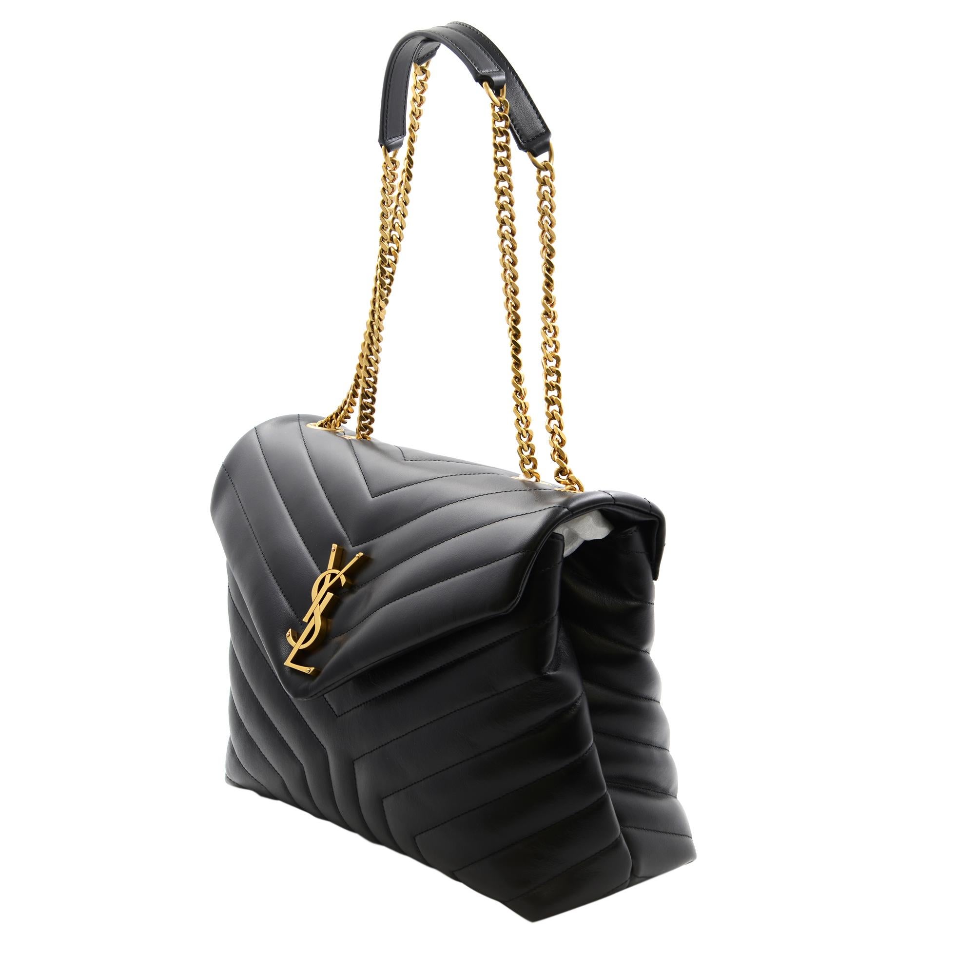 Saint Laurent luxe quilted leather shoulder bag with convertible chain straps. Features, top handle, foldover flap, gold tone hardware, quilted finish leather. Made in Italy. Medium size. Measurements: W 12 inches  x  H 9 inches  x  D 4.5 inches.