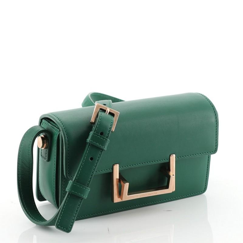 This Saint Laurent Lulu Shoulder Bag Leather Small, crafted from green leather, features an adjustable crossbody strap, front flap with double rectangular clasp and gold-tone hardware. Its clasp closure opens to a green suede interior with side slip