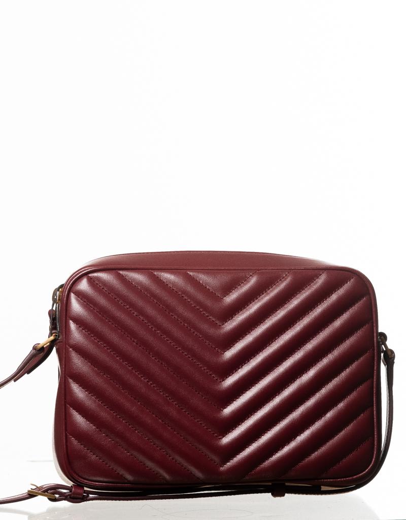 Inspired by vintage camera bags, this crossbody bag is made from chevron matelassé leather in burgundy. Featuring chevron matelassé stitching, aged gold-tone hardware, metallic logo plaque at front, zip closure, black grosgrain lining and an