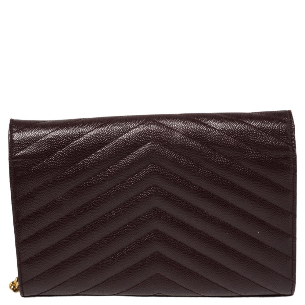 Fashioned using quilted matelassé leather into a smart silhouette, this Saint Laurent wallet on chain has high style and a timeless charm. It has a flap design and the front is highlighted with a gold-tone YSL logo. The interior is lined with nylon