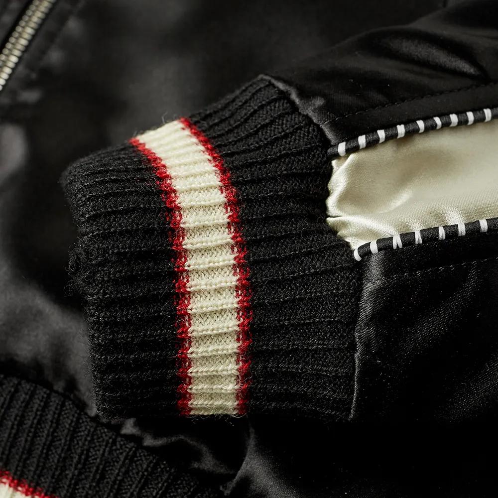 Saint Laurent Mens Birds Of Paradise Embroidered Teddy / Varsity Jacket

A Saint Laurent signature, the teddy jacket is a core piece of the house’s collective, and this version hits top tier with its luxe silk finish. With floral embroidery nodding