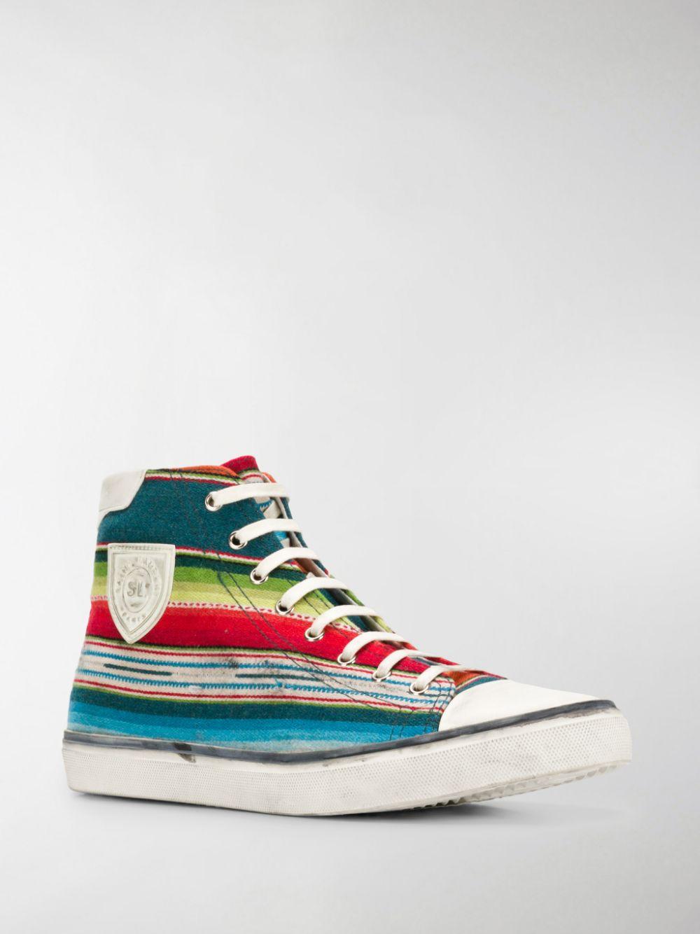 Saint Laurent Mens 'Mexican Jacquard' Bedford High Top Sneakers

These multicoloured Saint Laurent Beford striped cotton high top sneakers feature a round toe, lace-up front, multicolored stripes, a logo patch at the side and a distressed rubber