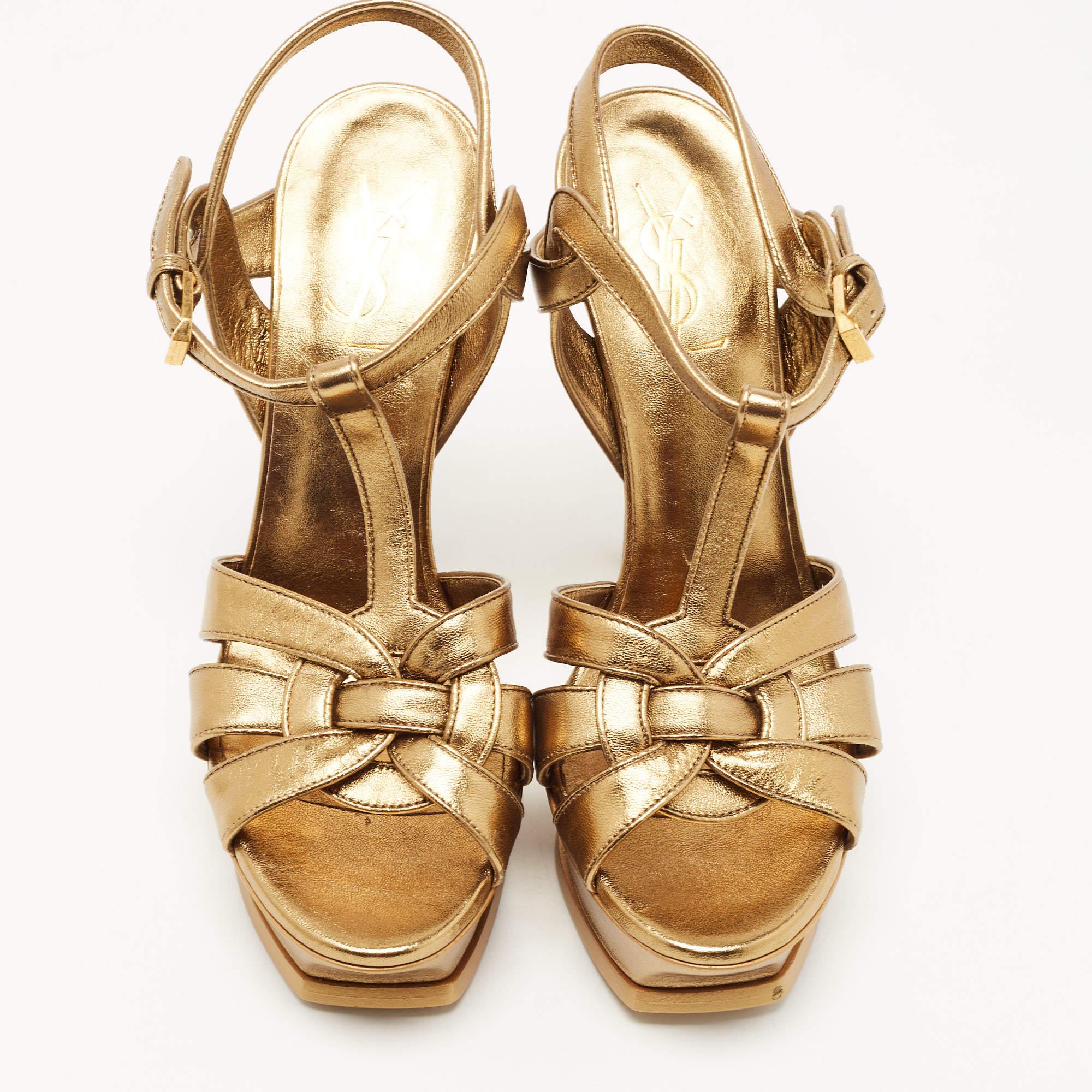 A timeless aesthetic and stellar craftsmanship in shoemaking are evident in these Saint Laurent platform sandals. From their interwoven construction using leather to the sturdy heels supported by platforms, these metallic gold-hued Tribute sandals