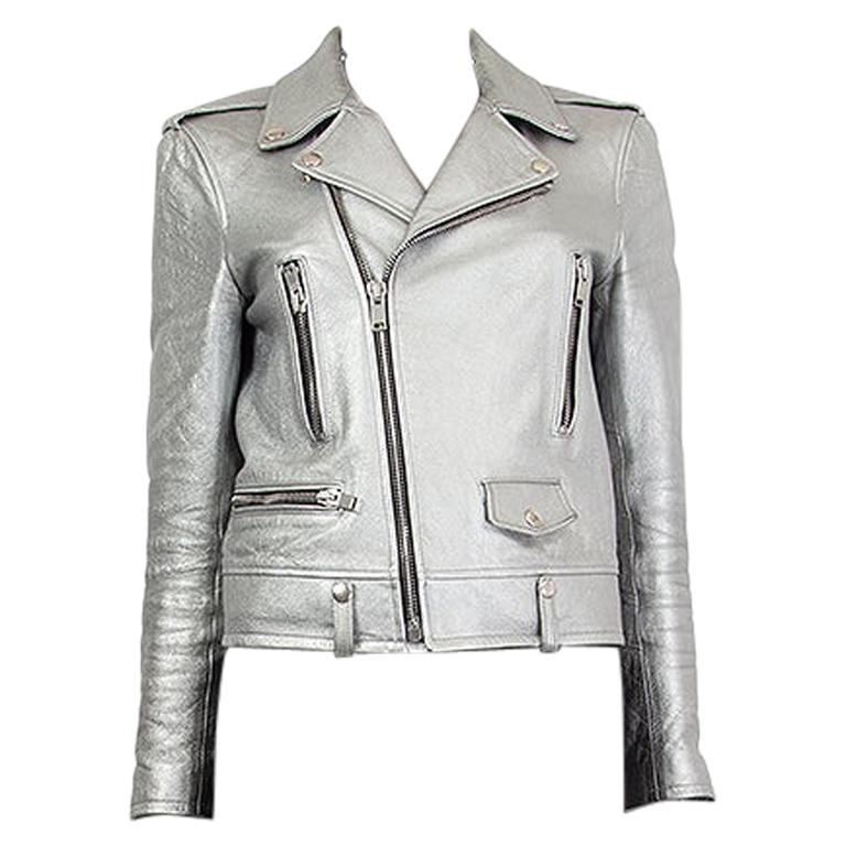 Saint Laurent classic motorcycle jacket in silver coated lamb leather with epaulettes, zipper pockets and one-snap fastening flap pocket. Has zipper on sleeves. Closes on the front with a silver tone zipper. There are signs of wear around one