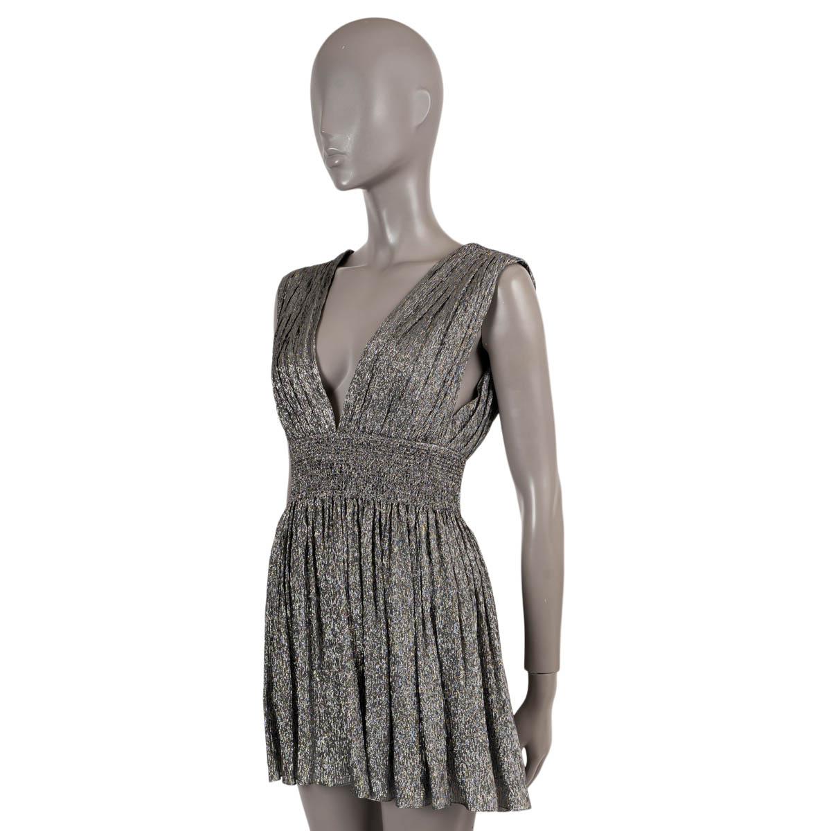100% authentic Saint Laurent sleeveless mini cocktail dress in metallic silver jersey silk (with 22% metallic fiber). Features a plunging V-neck silhouette with a low-cut back and a smocked waistband and loosely ruffled mini skirt. Opens with a