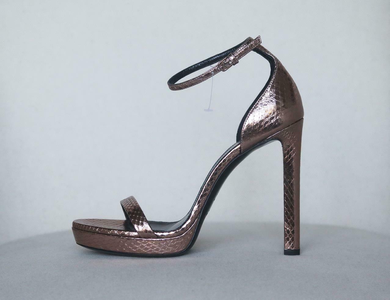 Saint Laurent's coveted 'Jane' sandals are updated this season in a bronze hue, they've been crafted in Italy from bronze snake-effect leather and have delicate ankle straps that buckles at the ankle. Heel measures approximately 110mm/ 4.5 inches