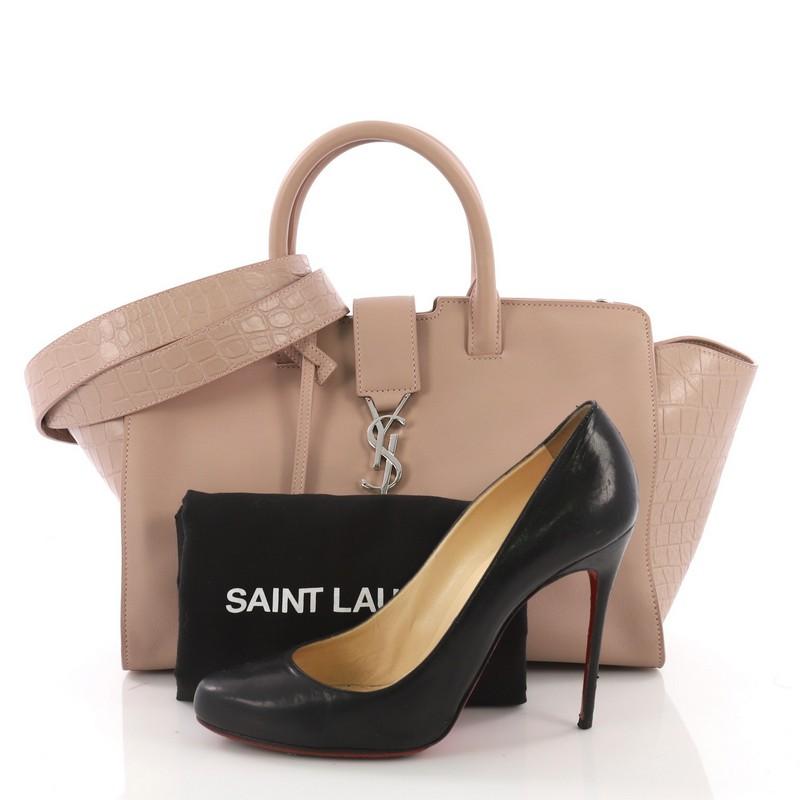 This Saint Laurent Monogram Cabas Downtown Leather with Crocodile Embossed Leather Small, crafted from nude leather with crocodile embossed leather, features dual rolled handles, YSL metal logo at the front, and silver-tone hardware. Its magnetic