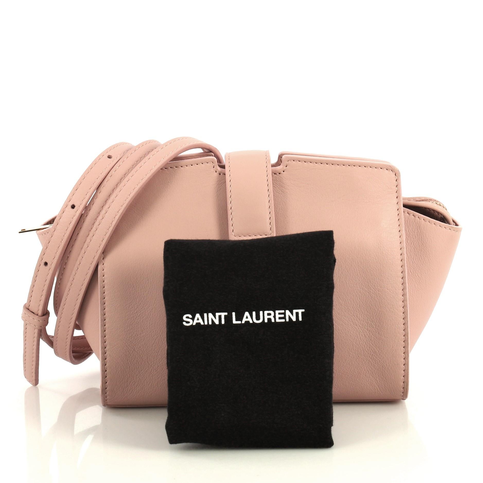 This Saint Laurent Monogram Cabas Leather Toy, crafted from pink leather, features a flat leather strap, YSL metal logo at the front, and gold-tone hardware. Its top flap magnetic snap and zip closure opens to a pink leather interior with slip