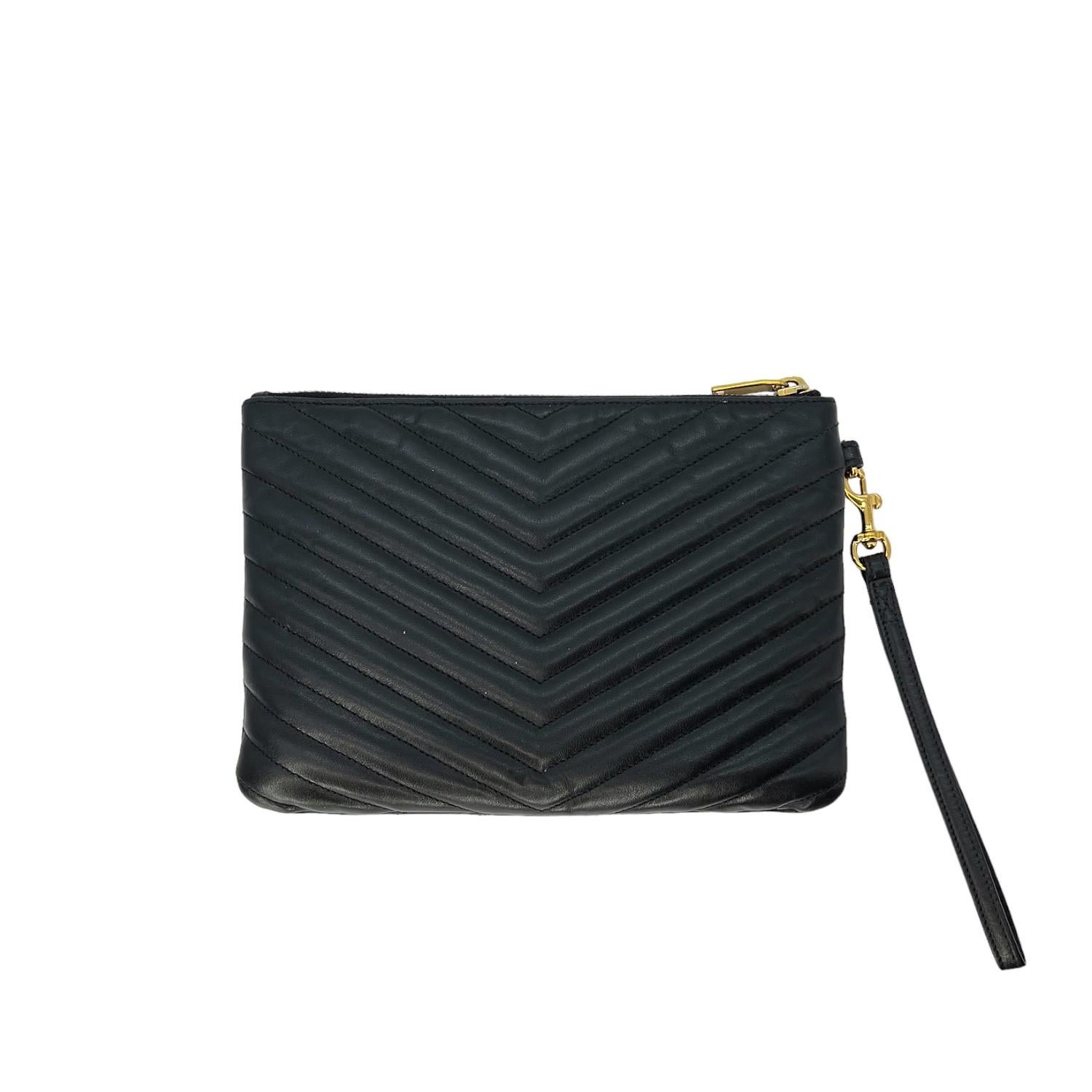 This Saint Laurent Monogram Matelassé Cassandre A5 Pouch was made in Italy and it is finely crafted of a quilted calfskin leather exterior with gold-tone hardware features. It has a removeable flat leather handle. It has a zipper closure that opens