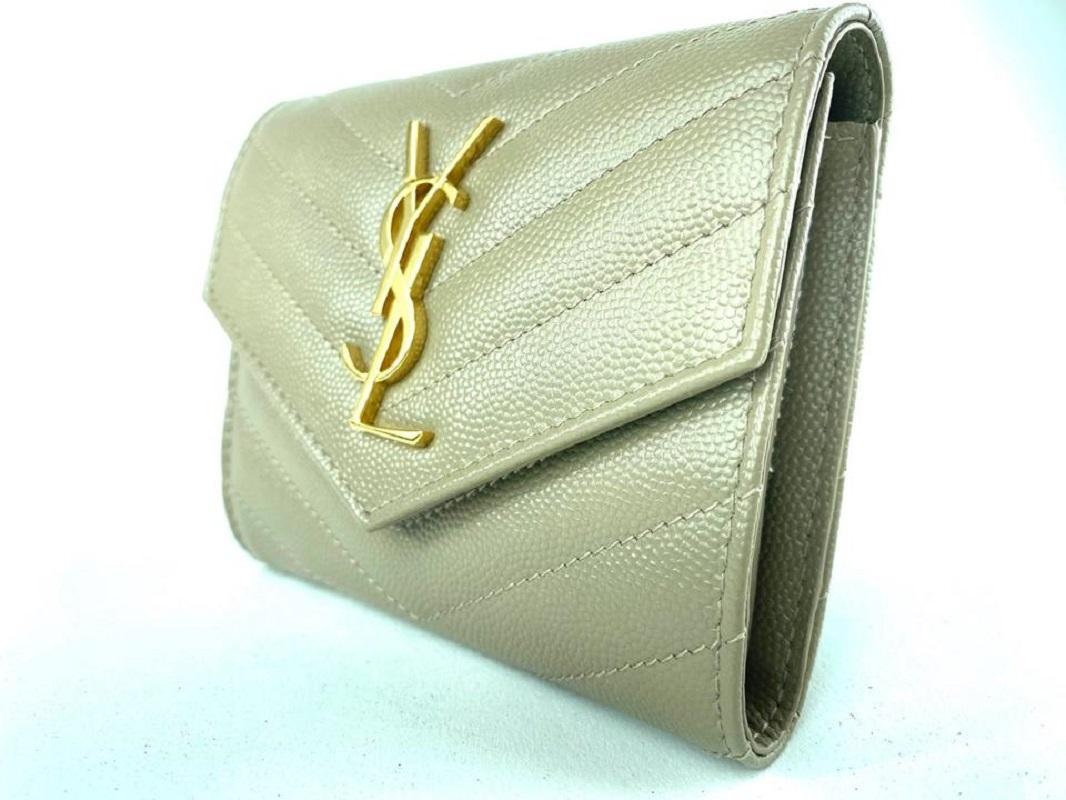 Saint Laurent chevron calfskin wallet with signature YSL monogram at center.
Envelope flap with snap closure.
Interior, one bill and six card slots.
Four slip pockets; zip coin slot.
3.9