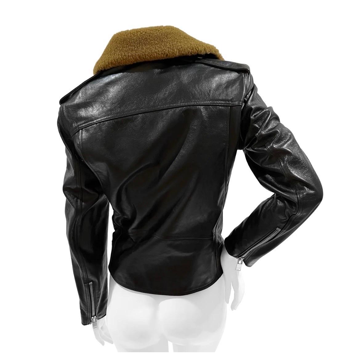 Motorcycle Leather Jacket with Shearling by Saint Laurent
Black leather
Tan shearling detail on collar
Asymmetrical zip up closure
Silver tone closure
Neckline collar has snap button closure
Dual side pockets with zip closure
Single small left