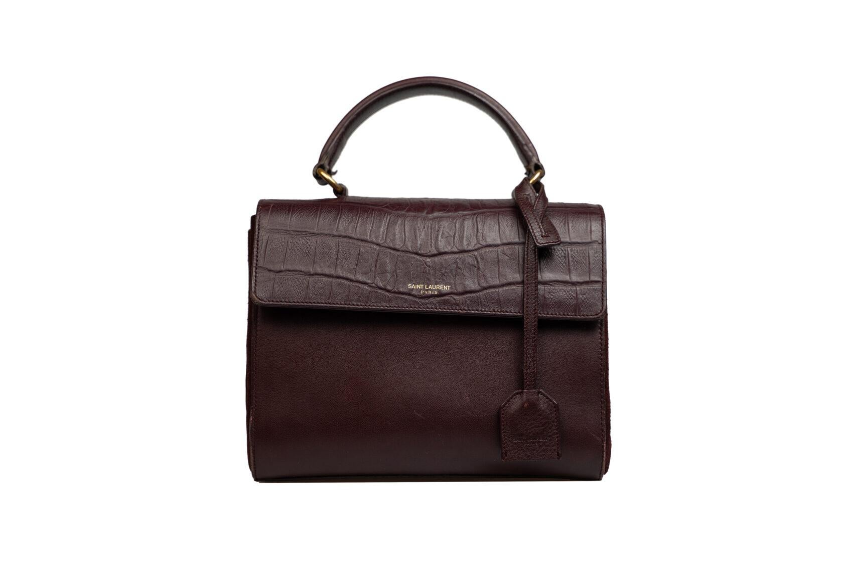 CONDITION: B: Very good condition with signs of use, visual scratches
PACKAGE: Shoulder strap
SIZE: 21/17/7 cm, Shoulder strap 117 cm
BRAND: SAINT LAURENT
MODEL: Moujik bag
COLOUR: Burgundy
MATERIAL: Leather/ Suede/ Crocodile embossed leather
INSIDE