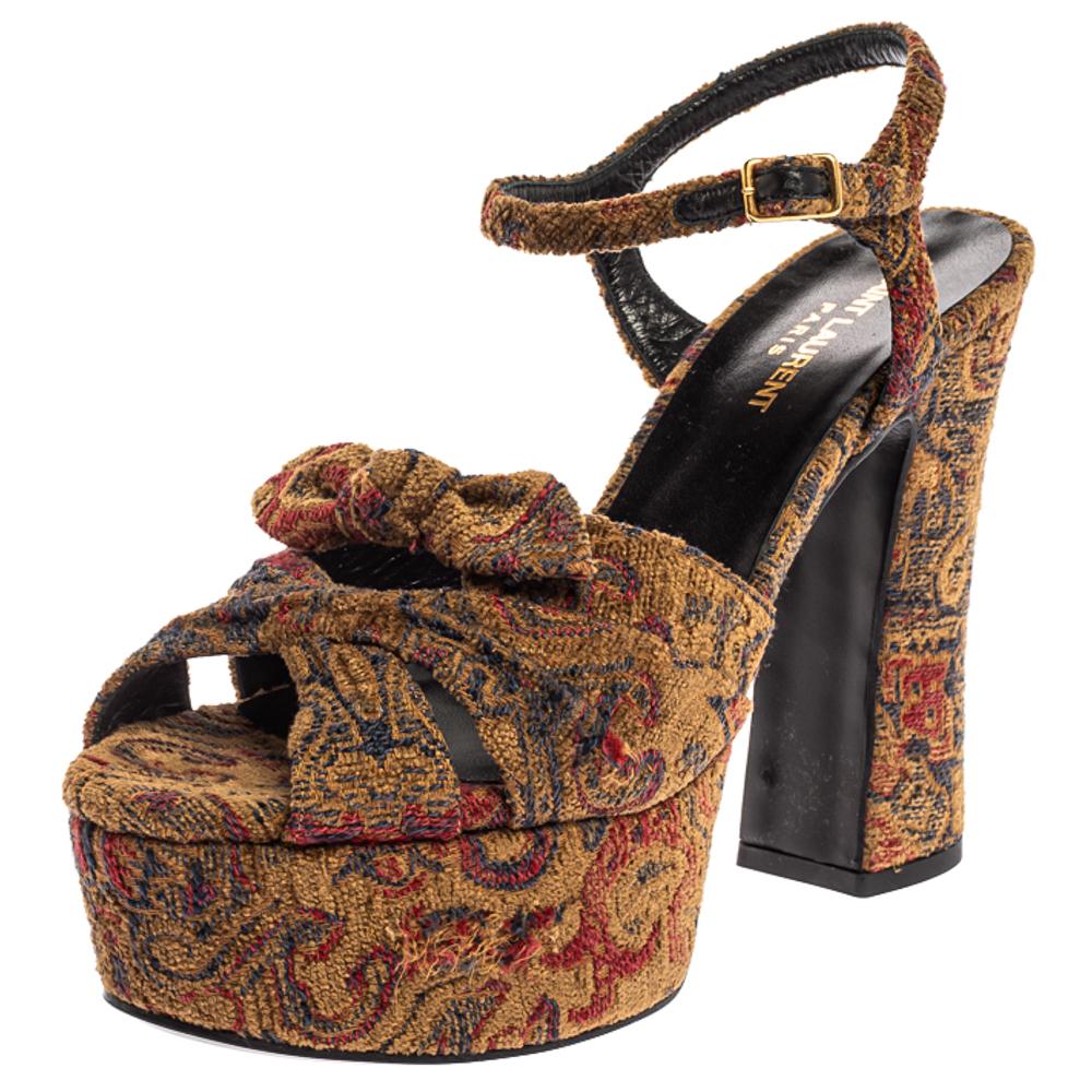 These sandals from Saint Laurent will lift you with ease. Crafted in Italy, they are made from brocade fabric and have a lovely silhouette. They feature open toes, Candy bows on the uppers, platforms, buckled ankle straps and 13 cm block