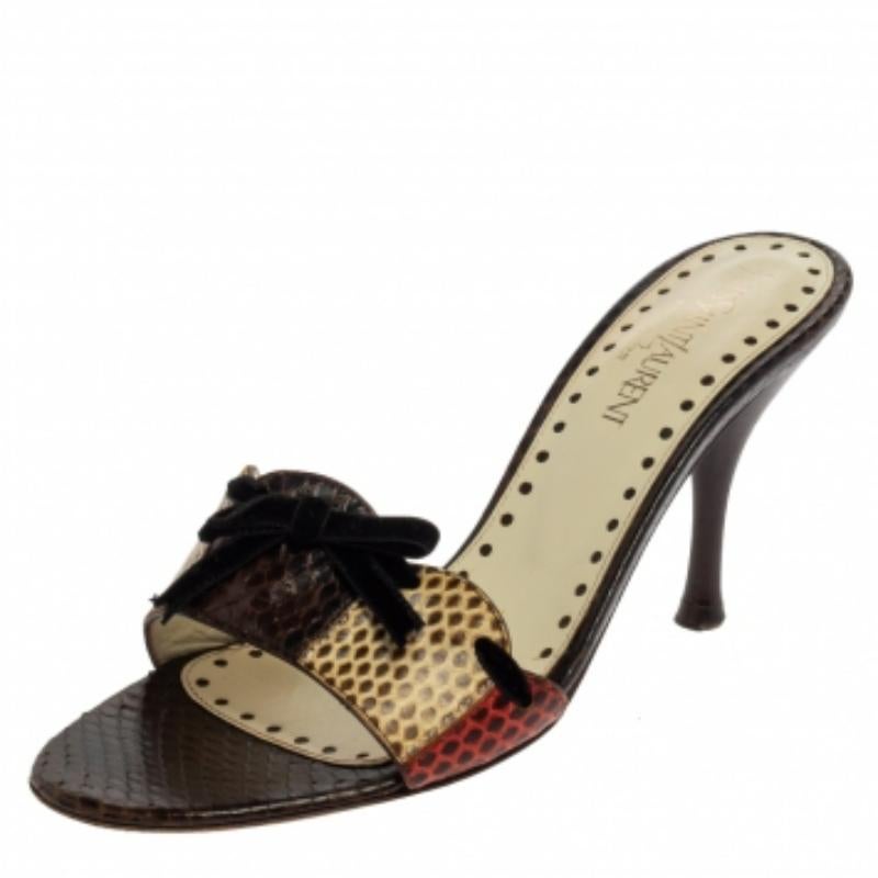 Perfect to compliment your feet are these lovely slides from Saint Laurent. The multicolored slides are crafted from exotic snakeskin and feature an open-toe silhouette. They flaunt bow detail on the vamps, comfortable leather-lined insoles, and 9.5