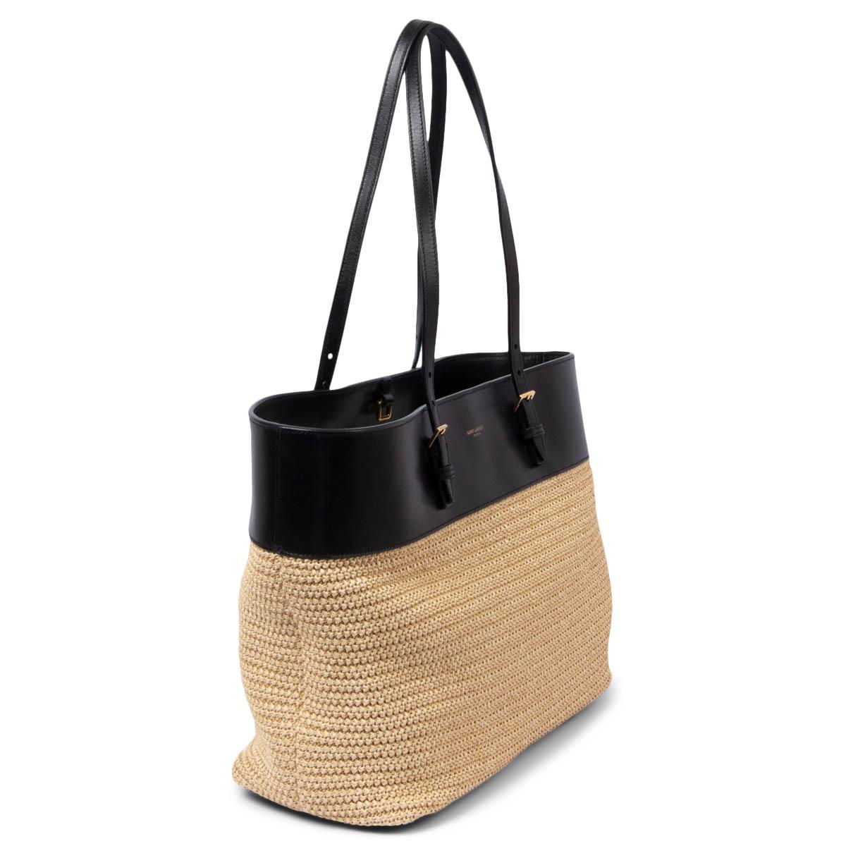100% authentic Saint Laurent Medium Shopping tote bag in natural raffia with black smooth leather trim. Opens with a leather strap on top and is lined in black grosgrain with one flat pocket against the back. Has been carried once and is in