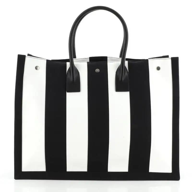 This tote is made of black and white striped canvas with 