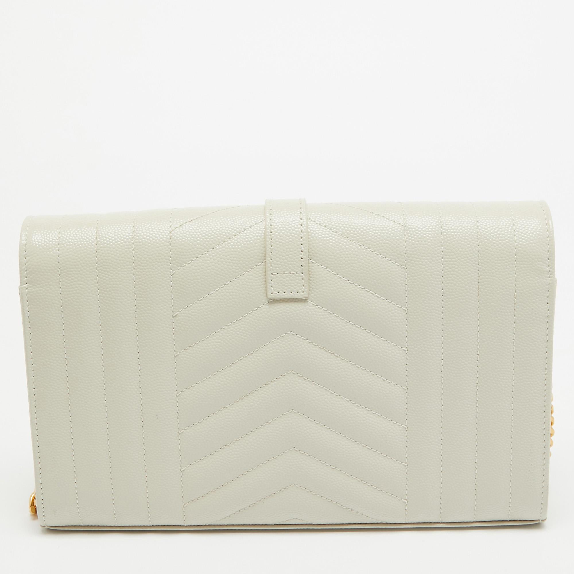 Fashioned using chevron-quilted leather into a structured silhouette, this Saint Laurent Monogram Envelope WOC has high style and a timeless charm. It has a flap design and the front is highlighted with a gold-tone YSL logo. The interior is lined