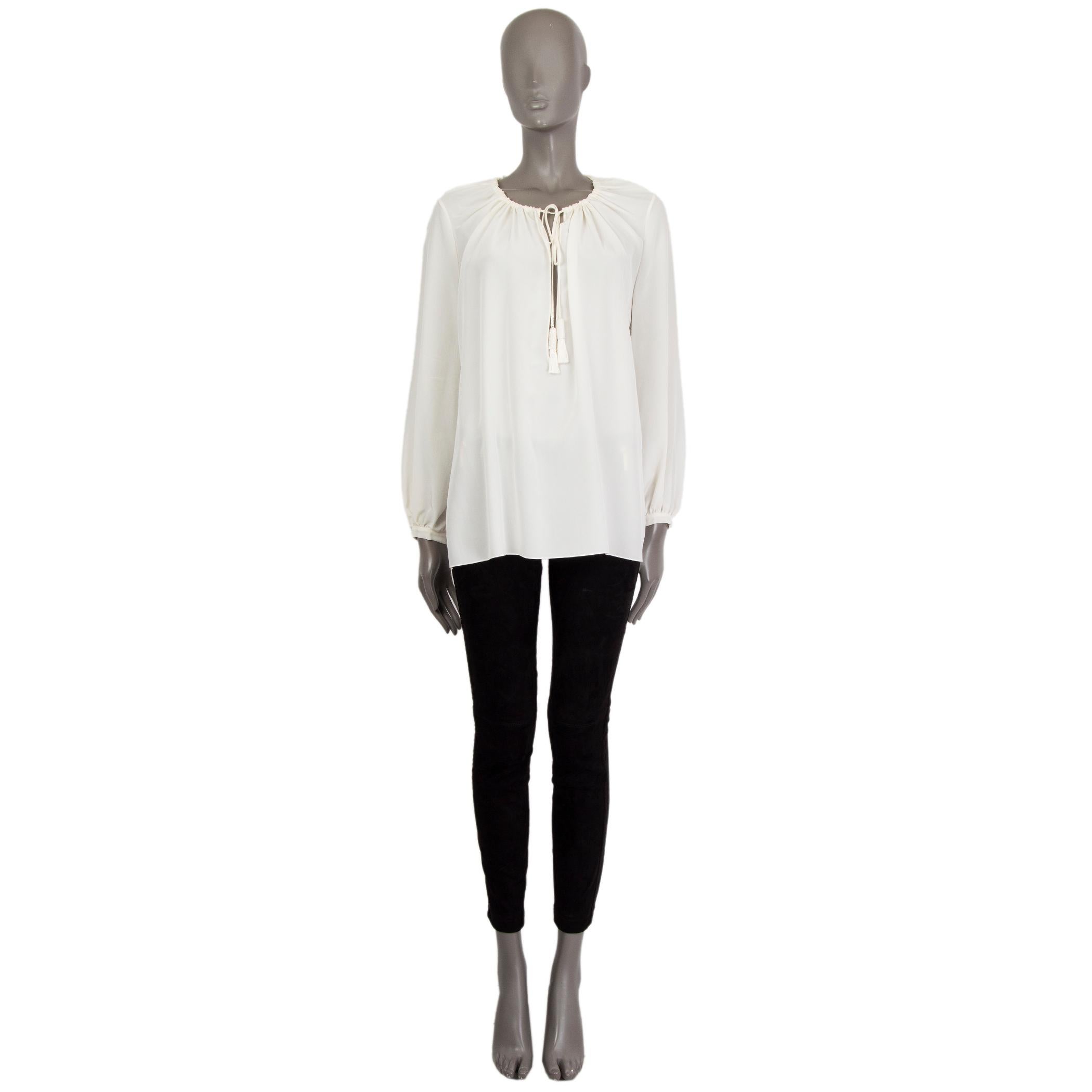 100% authentic Saint Laurent peasant blouse in off-white silk (100%) with a keyhole-neck. Closes on the front with string-tassels and buttons on the cuffs. Unlined. Has been worn and is in excellent condition. 

Measurements
Tag