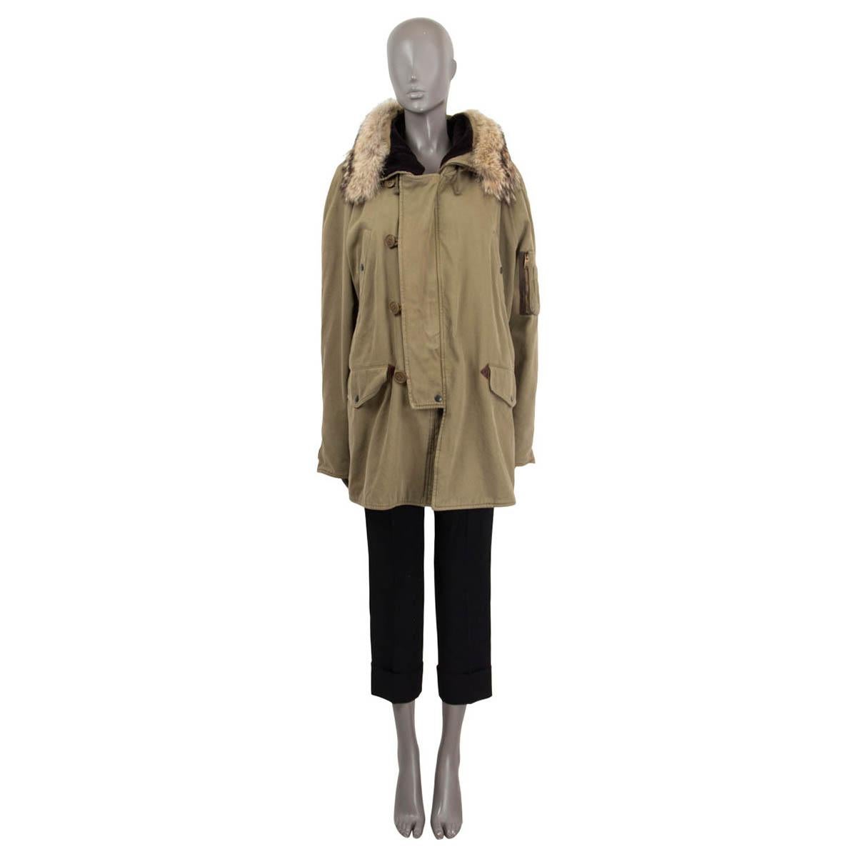 100% authentic Saint Laurent parka in olive green cotton (100%) with a coyotte fur (100%) hood. Features a drawstring at the inside waist, two buttoned flap pockets and two buttoned slit pockets on the front. Has long raglan sleeves (sleeve