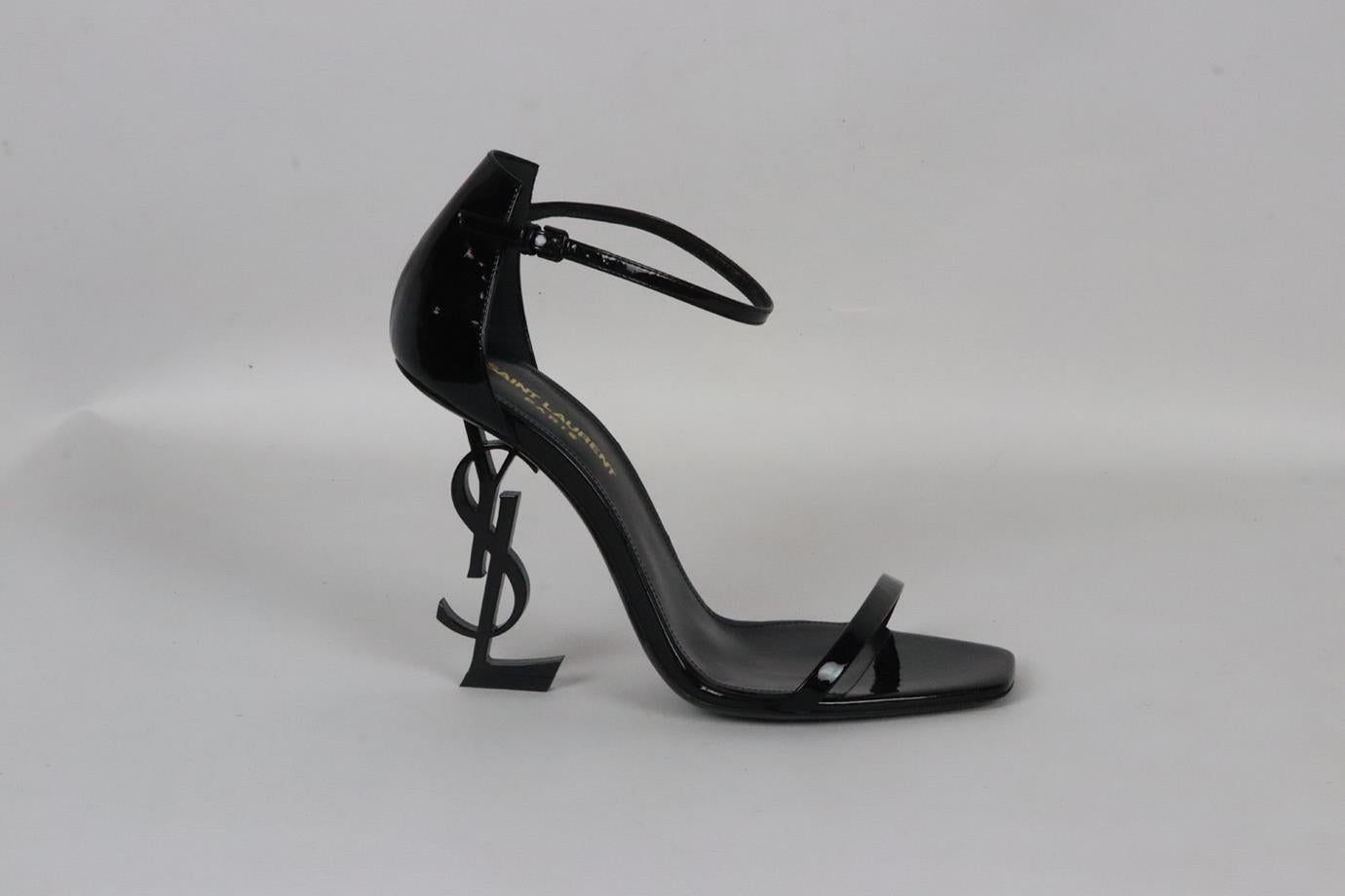 Saint Laurent Opyum patent leather sandals. Black. Buckle fastening at side. Does not come with dustbag or box. Size: EU 38 (UK 5, US 8). Insole: 9.4 in. Heel Height: 3.8 in. Platform: 0.2 in. Very good condition - Worn once. Light wear to soles;