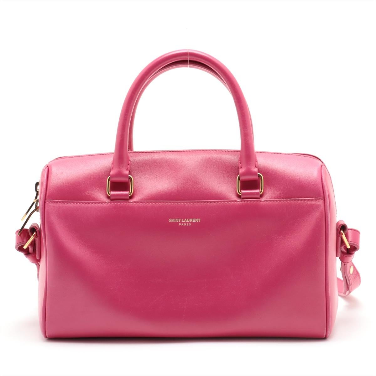 Le sac à main bidirectionnel en cuir Baby Duffle de Saint Laurent Paris, en rose, est un accessoire chic et polyvalent qui incarne l'élégance moderne. Confectionné en cuir souple, ce sac à main élégant présente une silhouette structurée et une