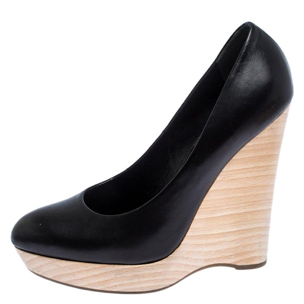 You are sure to make an impressive style statement in these Maryna pumps from Saint Laurent Paris! These black pumps are crafted from leather and feature covered toes. They come equipped with comfortable insoles and are elevated on 14 cm wedge
