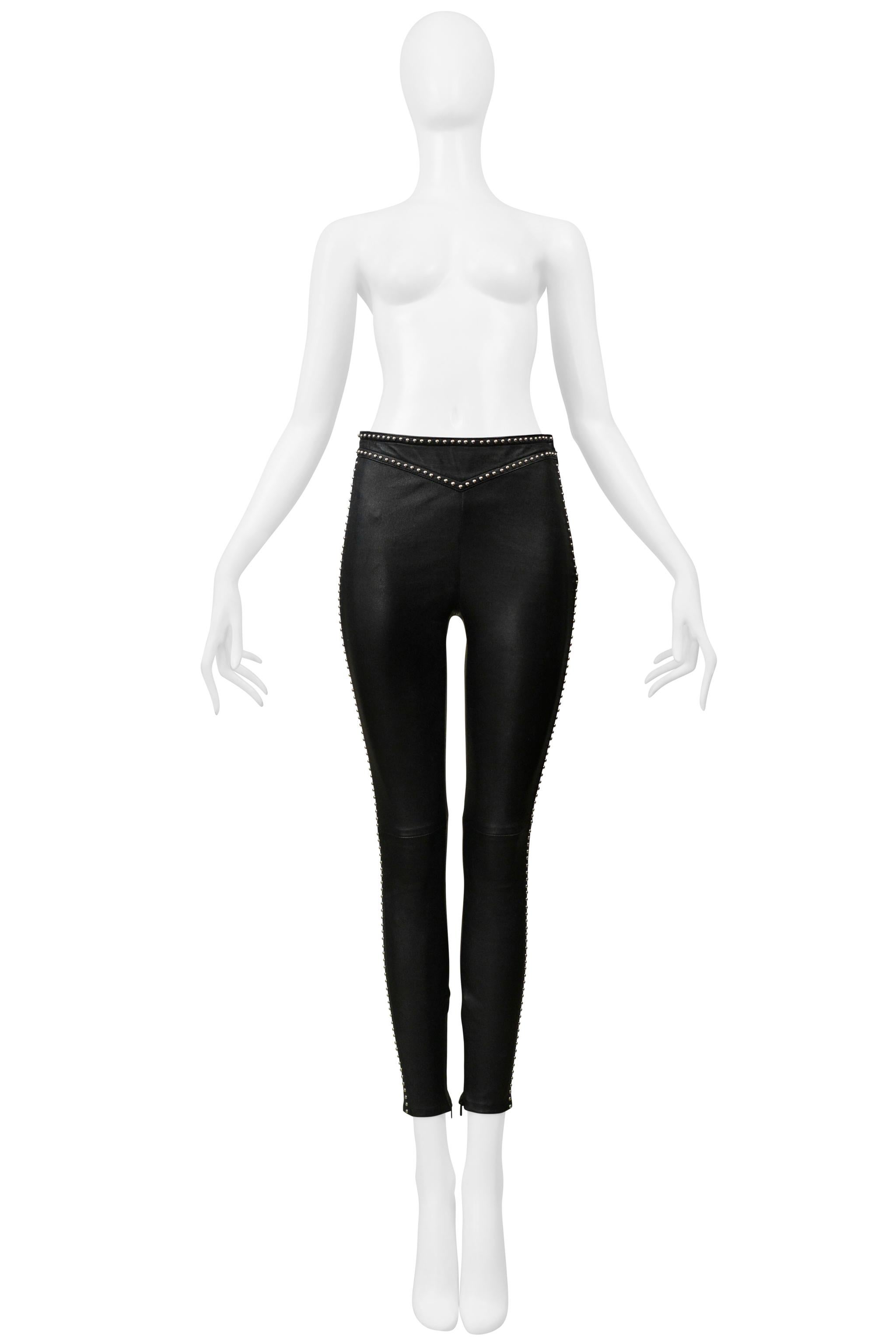 Resurrection Vintage is thrilled to present a pair of Saint Laurent Paris black leather rock-n-roll pants with stretch featuring a slim fit, silver studs, ankle zippers, and a side zipper.  

Saint Laurent Paris 

Size: Label Missing. Fits Lika A