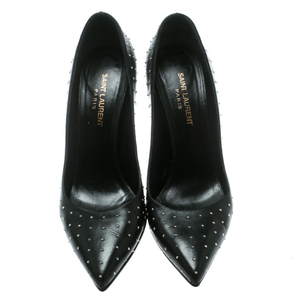 Look sparkling and pleasant in this pair of enchanting pumps from Saint Laurent Paris! These black pumps have been crafted from leather and styled with pointed toes. They flaunt silver-tone studs adorning the exterior and come equipped with