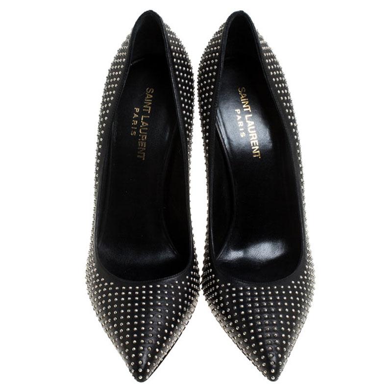 Walk with grace and confidence in these pumps by Saint Laurent Paris. Styled in a black shade with pointed toes, studs all over the exterior and leather insoles that provide comfort, these leather pumps will never fail to lift your outfits. Complete