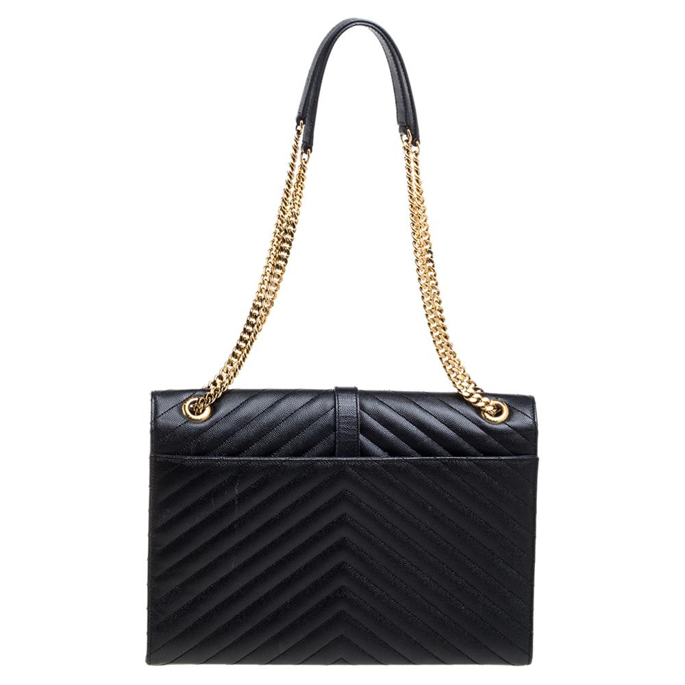 This exquisite Cassandre bag from Saint Laurent Paris is a chic accessory that represents the brand's rich aesthetics and elegant designs. Crafted from black leather, this easy-to-carry bag has a flap style with the YSL logo in gold-tone on the