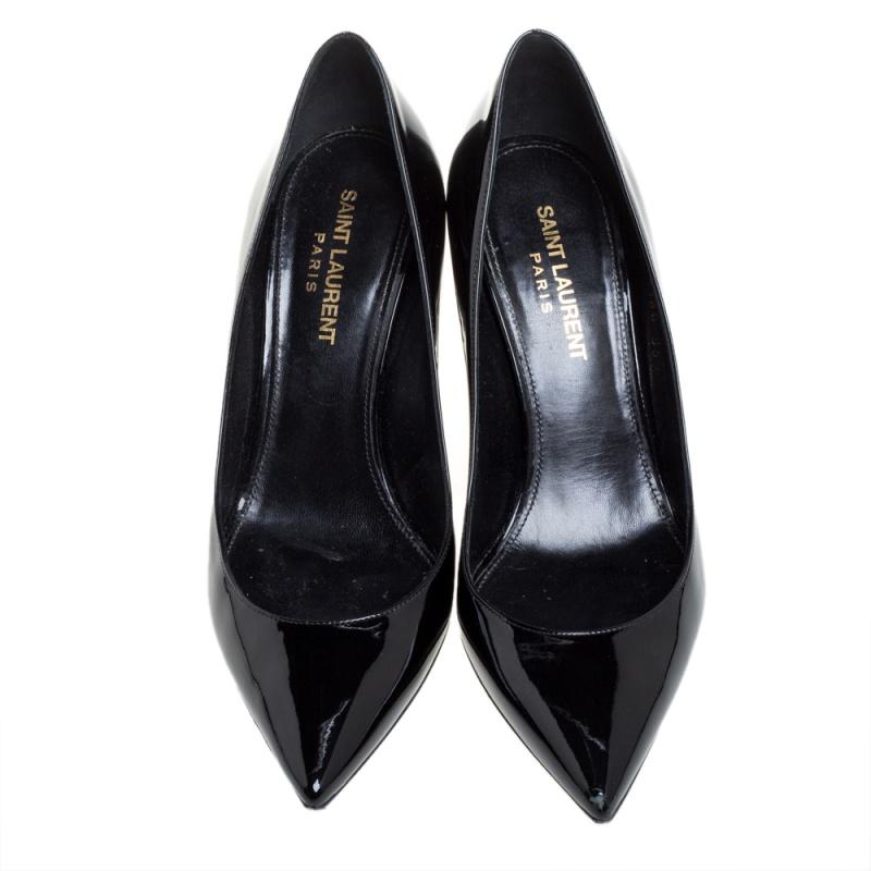 These Saint Laurent Paris pumps are timeless. They are crafted from black patent leather and styled with pointed toes and 'YSL' logo shaped heels. They come equipped with comfortable leather-lined insoles and will look great with a lot of your